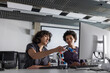 © ReeldealHD images - Two female engineers working on a robotic arm