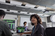 © ReeldealHD images - Female computer programmer looking up in a busy office