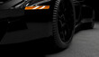 © Westend61 - Close-up of a black luxury sports car on the road in a dark setting, 3D rendering.