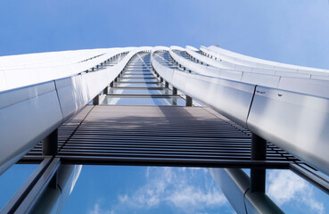 Skyscraper wall close-up. Rows of windows against the blue sky. Glass and concrete.