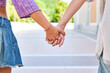 © ADDICTIVE STOCK - Lesbian couple holding hands in a loving gesture