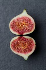 Fresh figs on a dark background, whole and sliced ripe, delicious and sweet figs with a kitchen knife on a dark tablecloth