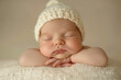 © Jana - A tiny baby with a knitted hat sleeping with a gentle smile on his face. Front face view with hands placed under head, soft pastel tones.