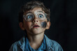© wolfhound911 - Brazilian boy scientist with soot on his face, standing in front of a black backdrop, his expression one of amazement and curiosity.