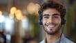 © CinimaticWorks - portrait of a smiling male call center operator, offering customer service and support through a headset, working in a modern office with professional communication and client interaction