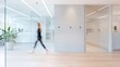 © Cdel - Modern Office Space, Energetic young woman strides through a sleek light-filled office featuring smooth concrete and glass, wooden floors, and customizable wall spaces for creativity.