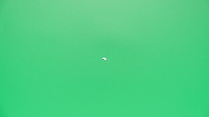 Stop motion animation of crumpled paper on a green background