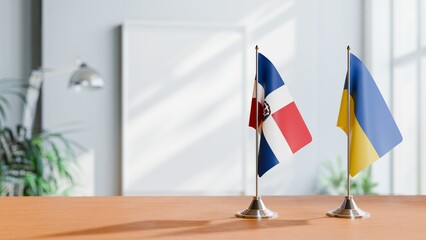 FLAGS OF DOMINICAN REPUBLIC AND UKRAINE ON TABLE