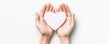 © Chawalit Hemman - Two hands gently hold a white heart against a light background, symbolizing love, care, and compassion.