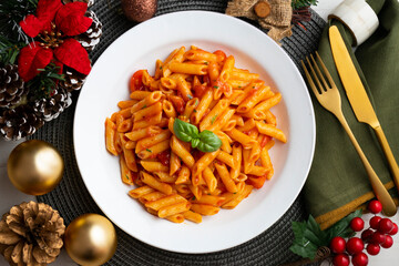 Macaroni with tomato and basil aroma. Top view table with Christmas decorations.