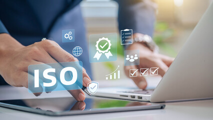 Leinwandbilder - ISO certification and quality management concept. Business professional reviewing ISO certification standards with digital icons representing quality control, management, and compliance processes.