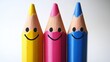 © Napasnan - Three smiling pencils with vibrant colors, standing upright on a white background, perfect for capturing joy in stationery design