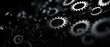 © Wan - Close-up of black mechanical gears in a dark environment, illustrating the concept of engineering, technology, and machinery.