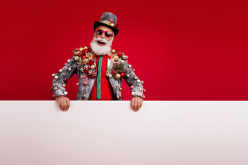 Wall Mural - Photo of happy cheerful old man white banner sales wear christmas tree balls costume sunglasses isolated red color background