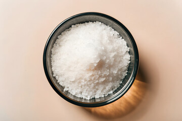 top view of salt on clear glass bolw isolated on white background