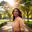 © AmolXNova - A woman wearing a fresh casual outfit, smiling as she walks through a park on a sunny day.