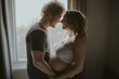 © dimedrol68 - Husband tenderly hugs his pregnant wife.