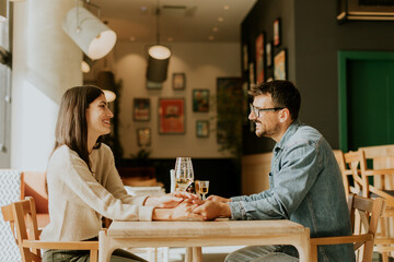 Cozy conversation between two friends over drinks in a warm, inviting café during a sunny afternoon