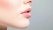 © Wimon - Close-up of a woman's lips with a soft and natural makeup look against a light background.