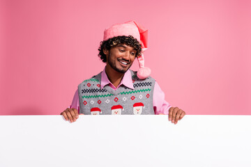 Sticker - Photo of funky cool guy dressed ornament vest santa headwear enjoying x-mas day rising placard emtpy space isolated pink color background