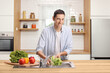 © Ljupco Smokovski - Young man washing vegetables in a kitchen sink