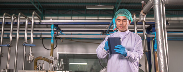 Worker Checking quality or checking stock of glass bottle in beverage factory. Worker QC working in a drink water factory