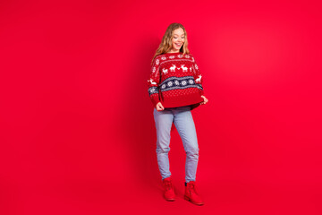 Poster - Full body portrait of nice young girl show sweater empty space isolated on new year xmas bright red color background