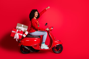 Wall Mural - Profile side photo of crazy excited girl wear pullover xmas gift delivery ride fast scooter isolated on red color background