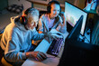 © Davor - Grandfather and granddaughter playing video games together on PC with headsets