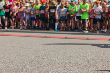 Wall Mural - Children marathon runners crowd, young teen sportsmen participants start running in the city streets, crowd of kids joggers in motion, kid group athletes outdoor run, family competition in summer day