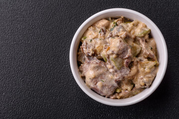 Bowl of food with beef, bulgur, tomatoes, zucchini and sauce