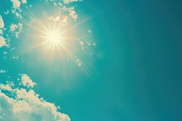 a bright sun is shining through puffy white clouds in a clear blue sky