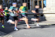 © Maren Winter - Group of runners in motion blur at the sports competition City Run across the old town of Lubeck on a sunny day, blurred motion, copy space