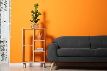 Wall Mural - Stylish sofa and decor elements near orange wall in room