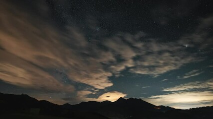 Wall Mural - milky way galaxy stars moving over alps mountains in summer starry night sky time lapse