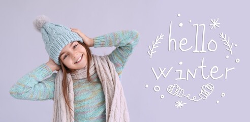 Wall Mural - Cute little girl in warm clothes on lilac background. Hello, winter