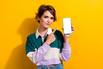 Wall Mural - Photo of good mood funny lady dressed polo shirt pointing finger modern device empty space isolated yellow color background