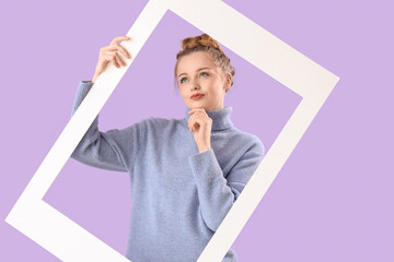 Sticker - Thoughtful beautiful young woman in warm sweater with frame on lilac background