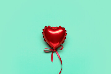 Wall Mural - Heart-shaped red balloon for Valentine's Day on turquoise background