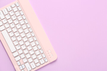 Wall Mural - Pink computer keyboard on lilac background. Top view