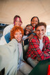 © Jose Calsina - Vertical. Happy group of diverse students taking a selfie together, capturing a moment of friendship, teamwork, and fun. Young people. Perfect for education, youth, social media, and group activities