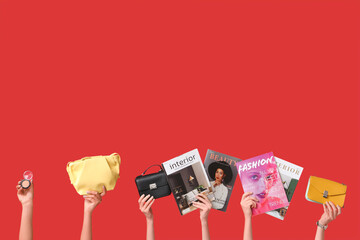 Poster - Female hands with different magazines, stylish bags and blush on red background