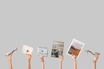 Poster - Female hands with different magazines, high heels and stylish bags on grey background