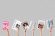 © Pixel-Shot - Female hands with different magazines and newspapers on grey background