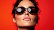 © Narongsag - Woman Wearing Stylish Sunglasses with Red Background   Fashion  Beauty  Eyewear  Portrait