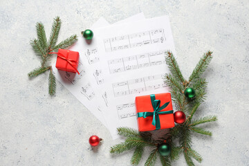 Poster - Composition with music sheets, Christmas gifts, balls and fir branches on light background