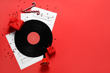 Poster - Composition with vinyl disc, music sheets and Christmas gifts on red background