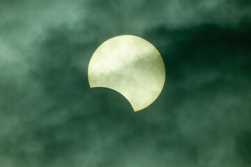 Wall Mural - Solar eclipse with clouds, a astronomical phenomena, the moon covers part or all of the sun