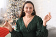 © Pixel-Shot - Happy young woman with Christmas sparkler in living room