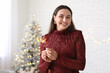© Pixel-Shot - Beautiful young woman with Christmas sparklers in living room